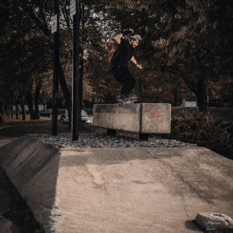 Team rider skating a custom deck on a concrete ledge
